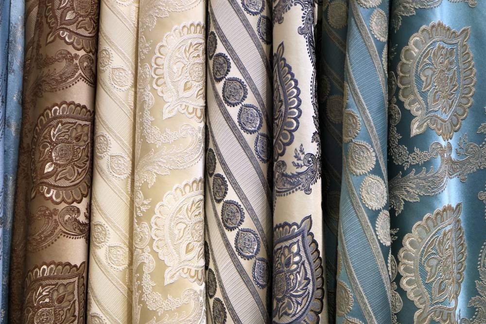 Cool and neutral printed drapery fabrics hanging in a drapery workroom near Peoria, Illinois (IL)